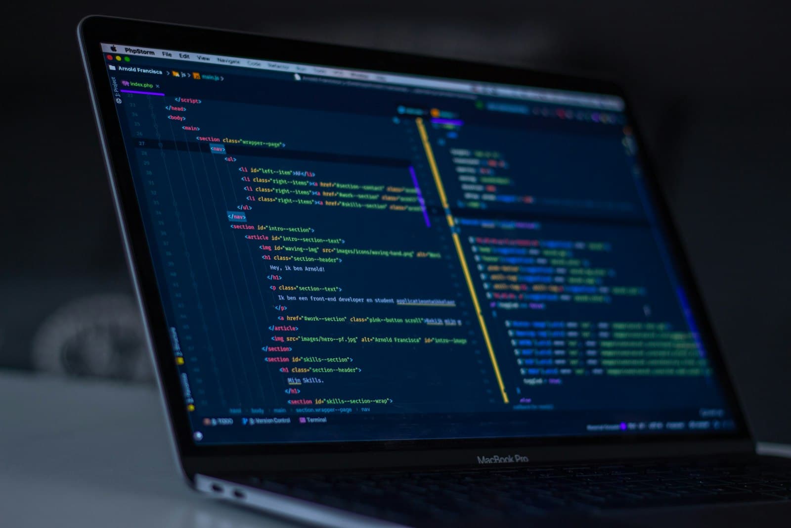 Developer laptop with application code on screen
